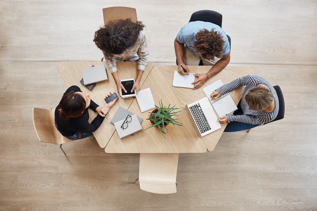 Coworkers sat around a desk